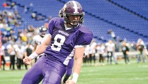 Grand Meadow's Perry Stejskal celebrates his first-quarter touchdown in 2013 during the Superlarks' Minnesota State Nine Man semifinal game against South Ridge in the Metrodome. -- Herald File Photo