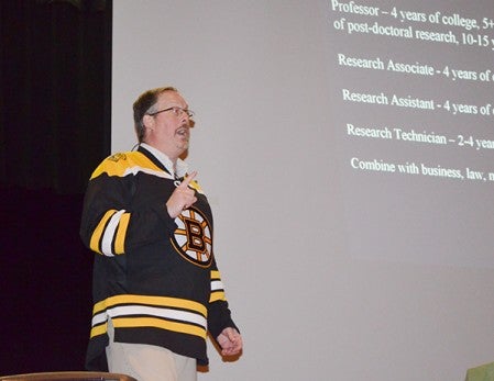 Ted Hinchcliffe, associate professor with The Hormel Institute, speaks at Ellis Middle School about pursuing a career in science.