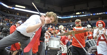 Austin band member William Bjorndal plays the cymbal during the game.