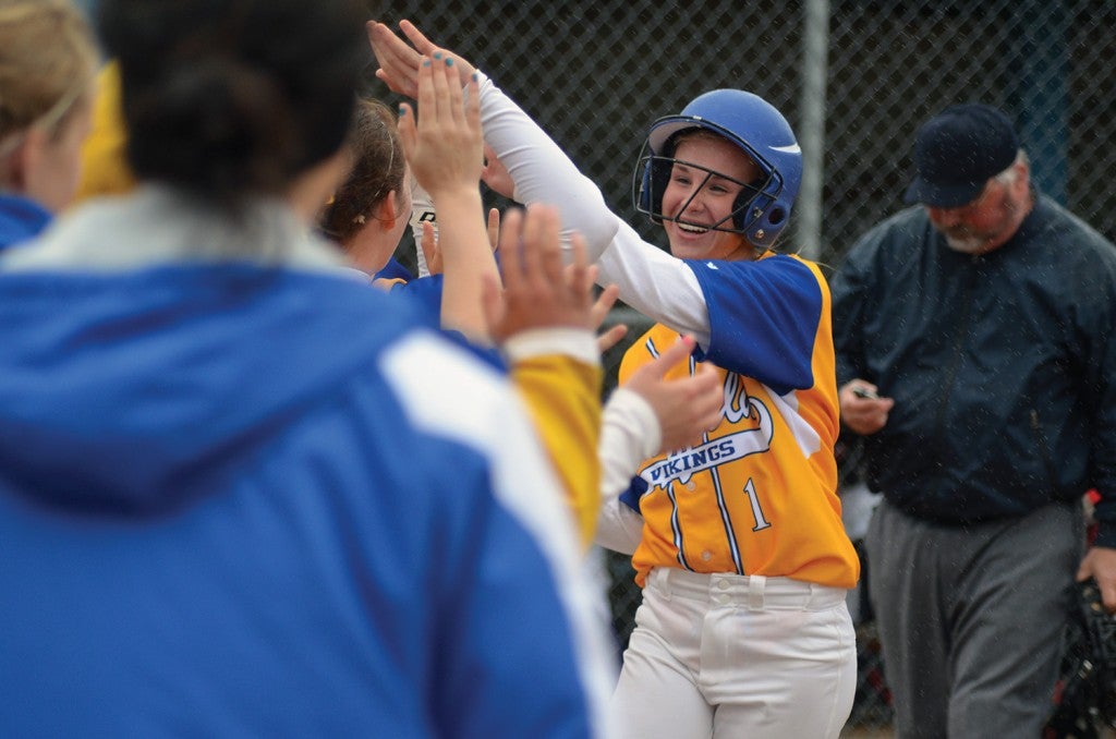 Hayfield's Jessie Foster is greeted by her teammates after she hit a two-run home run in the Vikings' 6-4 loss to Kenyon-Wanamingo in the Section 1A West Division tournament in Hayfield Thursday. -- Rocky Hulne/sports@austindailyherald.com