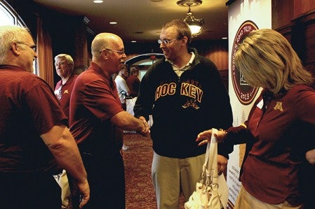 Jacob Ulland of Austin, right, meets Gopher Football head coach Jerry Kill Monday in Austin.