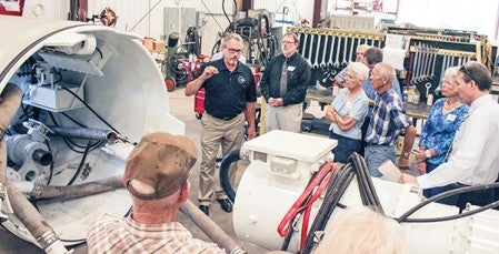 Maynard Akkerman explains how a microtunneling device works. Matt Peterson/matt.peterson@austindailyherald.com