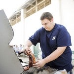 Randy Klouse places a sirloin on the grill Tuesday during a beef cookout at the Mower County Fair.