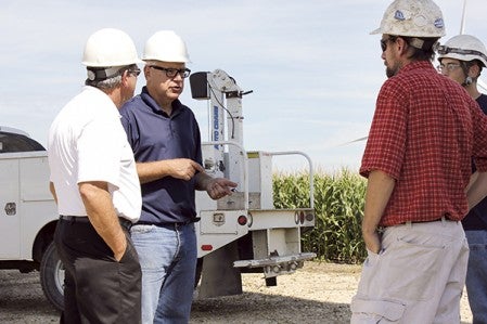 U.S. Rep. Tim Walz talks to Mike Barrios, left, general manager of Midwest Wind, and wind energy technicians Thursday near Grand Meadow.