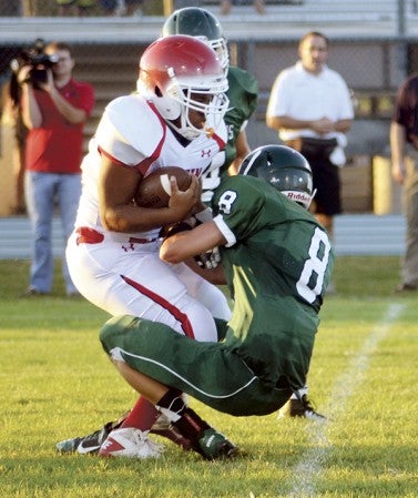 Austin's Cory Hepler breaks a tackle attempt by Faribault's Danny Ehlers in Faribault Friday. The Packers lost 35-21. -- Rocky Hulne/sports@austindailyherald.com