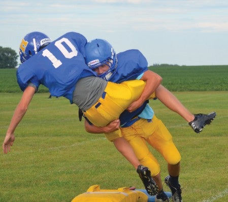 Hayfield's CarterPesch brings down teammate Mat Walters in practice in Hayfield Thursday. The Vikings are changing conferences this year as the Hiawatha Valley League and Three Rivers Conference have combined for football. -- Rocky Hulne/sports@austindailyherald.com