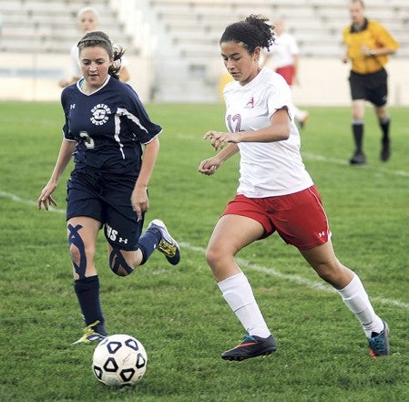 Austin's Grace Dehoogh moves the ball forward beside Rochester Century's Brie LaPlante in the first half Thursday night at Art Hass Stadium. Eric Johnson/photodesk@austindailyherald.com