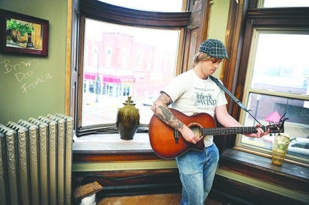 Joshua Whalen performs upstairs in the old Bank Building during an open house of the building. Whalen takes every opportunity to perform and get his sound out.  Eric Johnson/photodesk@austindailyherald.com