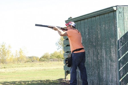 Alex Fiebelkorn of the AHS trapshooting team swings his barrel at a clay pigeon during the skeet shoot round.