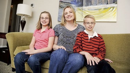 Amy Cobb sits with her children, Savannah and Wilson, in their home. Both children are home-schooled through the MTS Minnesota Connections Academy, an online school out of St. Paul. 