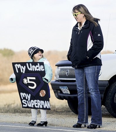 Four-year-old Cloey Breitbarth stands with her mom Nikki Breitbarth as they wait for the Grand Meadow Superlarks.