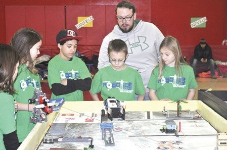 Southgate Elementary teacher Paul White watches as the Southgate Gators robotics team tests their robot.
