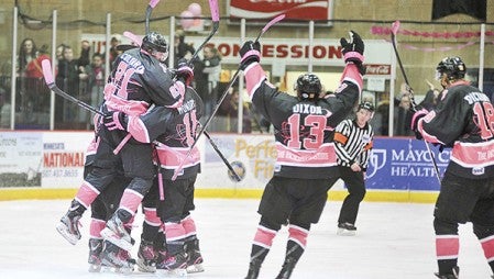 Members of the Bruins mob CJ Smith after scoring the winning goal of the shootout with Brookings at last year’s Paint the Rink Pink, which was the starting point of Paint the Town Pink four years ago. From there the city and now county effort has grown into a large fundraiser. Herald file photo