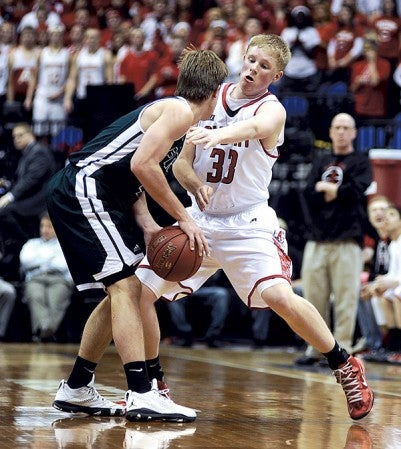 Austin's Curtis Oberbroeckling defends Holy Family's Kyle Schumer during the first half Thursday in the Class AAA semifinals of the Minnesota State Boys Basketball Tournament at Target Center. Eric Johnson/photodesk@austindailyherald.com