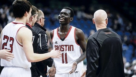 Austin's Ajuda Nywesh was all smiles Thursday as the Packers wrapped up their Class AAA semifinal win over Holy Family in the Minnesota State Boys Basketball Tournament at Target Center. Herald File Photo