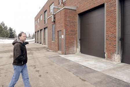 Todd Jorgenson, with Austin Utilities, shows parts of a garage where some of the bays closest to him have been revamped to house the bigger boom trucks for repairs.Eric Johnson/photodesk@austindailyherald.com