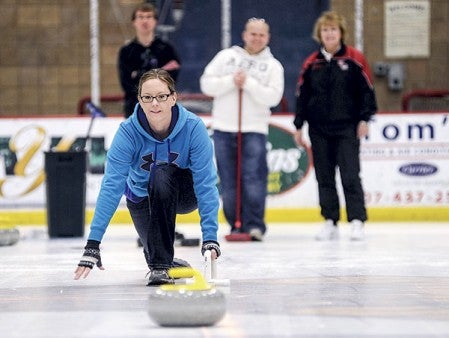 Nicole Peterson of Albert Lea watches a stone glide across the ice at Riverside Arena during a curling open house Saturday afternoon.  Eric Johnson/photodesk@austindailyherald.com