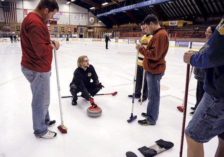 Michael McEniry goes over some things about sweeping during a curling open house. McEniry participates in the Owatonna Curling Club. 