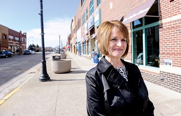 Jeanine Nelson is pictured along Main Street Friday morning. Nelson is taking over Jeff Baldus’ position as head of member relations and major events.  Eric Johnson/photodesk@austindailyherald.com