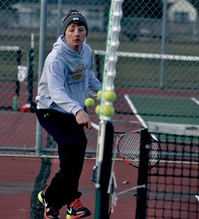 Austin's Owen Nelson closes in on the ball during his No. 2 doubles match against Fairmont at Paulson Courts Monday. -- Rocky Hulne/sports@austindailyherald.com