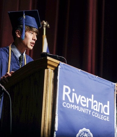 Riverland graduate Clyde Carver, a 16-year-old from Austin, gives his address Friday night during the Rvierland Community College commencement exercise at Knowlton Auditorium. Eric Johnson/photodesk@austindailyherald.com