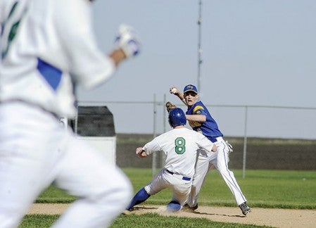 Hayfield's Cam Rutledge relays the throw after getting the force out on Lyle-Pacelli's Braden Kocer in their Section 1A West Division playoff game Thursday in Hayfield. Eric Johnson/photodesk@austindailyherald.com