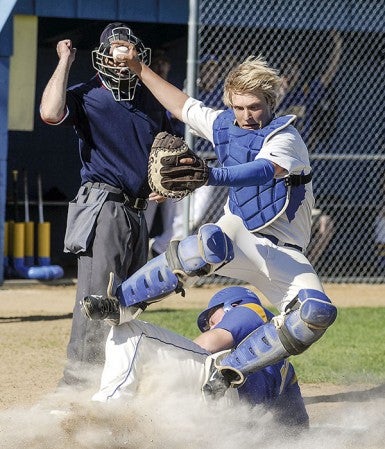 Lyle-Pacelli catcher Lee Bauer is upended by Hayfield's John Stackhouse in the first inning of their Section 1A West Division playoff game in Hayfield Thursday. Eric Johnson/photodesk@austindailyherald.com