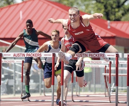 Austin's Adam Bergstrom clears the final hurdle on the way to winning his heat in the 110 high hurdles at the Big Nine Track Meet Friday. Eric Johnson/photodesk@austindailyherald.com