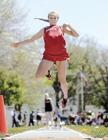 Austin's Carolyn Hackel makes her final jump in the long jump prelims Friday during the Big Nine Meet. Eric Johnson/photodesk@austindailyherald.com