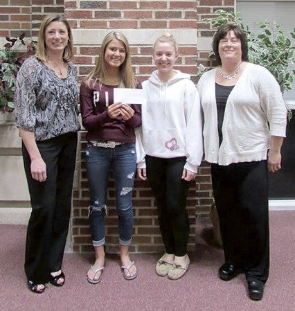 Several Groups donated to the Women’s Leadership Initiatives recent backpack program. AHS Youth Leadership’s Madi Klein and Chloe Thorpe present a check to Holly Johnson, Jill Hart. Photo provided