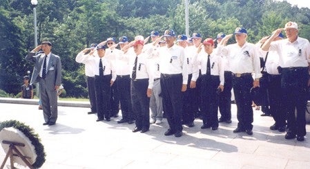 Norman Mathews salutes with fellow soliders on a trip to Osan, South Korea in 1992. Herald file photo
