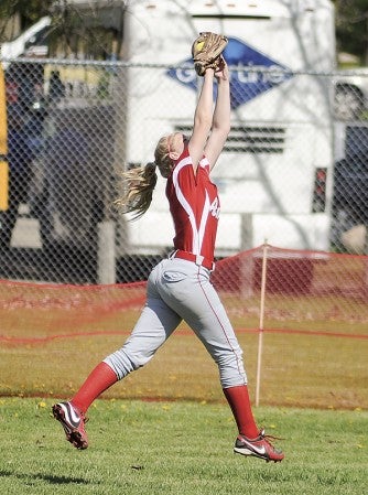 Austin's Erin Dankert pulls the ball out of the air on the run against Winona in the Section 1AAA tournament Friday at Todd Park. Eric Johnson/photodesk@austindailyherald.com