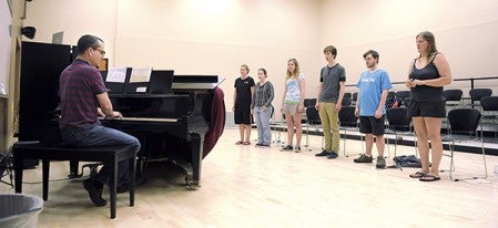 Riverland Community College music director Scott Blankenbaker runs RCC singers through rehearsel Tuesday morning. Members of the concert choir will be traveling to New York City in June to take part in the Masterworks Festival. Eric Johnson/photodesk@austindailyherald.com