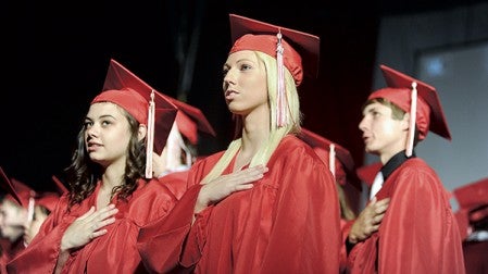 Abigail Prizler says the Pledge of Allegiance with the rest of her class during AHS commencement Friday night at Riverside Arena. Eric Johnson/photodesk@austindailyherald.com