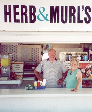 Murl Loecher is pictured with her husband Herb at their popular stand at the Mower County Fair.  Photo provided