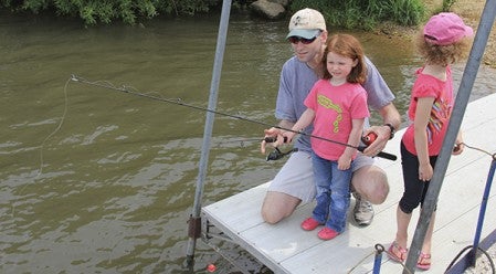 Jason Baron, from left, fishes with his daughters, Jacey, 3, and Adah, 6, Saturday.