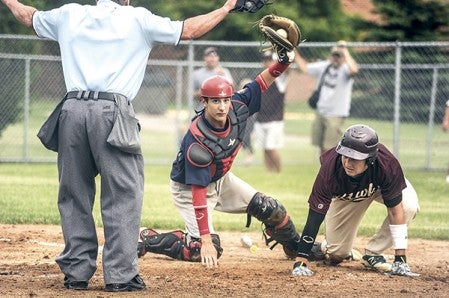 Dylan Gasner holds up the ball opening to get the call on Rochester's David Brust. Herald File Photo