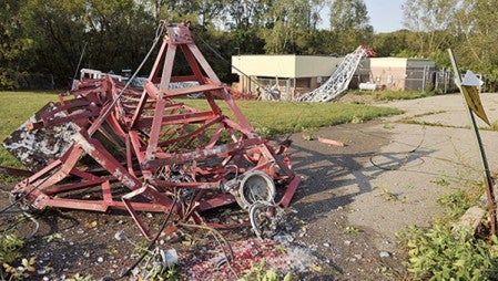 The very top of KSMQ's transmitter tower laid partially on the parking lot in the southwest corner of the Riverland Community College west campus in September of 2012. The tower, owned by KSMQ, fell at around midnight as powerful storms swept through the area. Herald file photo