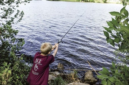 Ray Wicks, 10, casts into East Side Lake during a fishing trip as part of the Jay C. Hormel Nature Center’s Heritage Survival Class Tuesday.