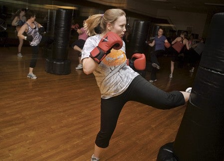 Kayla Sellers works out during the YMCA kick-boxing class. The minimum wage increase could see a membership and program fee hike. Herald file photo