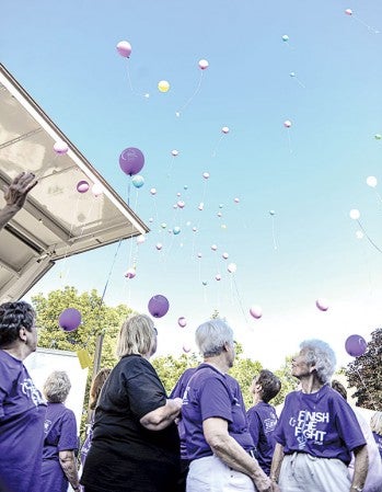 Cancer survivors turn to watch their balloons float up into the air after the Survivors Walk at the July 26 Mower County Relay for Life. Herald file photo