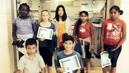 Fifth- and sixth-grade “Report Out” winners were, back row from left, Nybol Deng, Alexis Crews, Rovi Sagala, Dallana Benicio Herrera, Alma Aguilar Ortiz; front row from left, Jose Mendez, Joel Garcia Espinoza. Not pictured: Leslie Noriega Martinez.