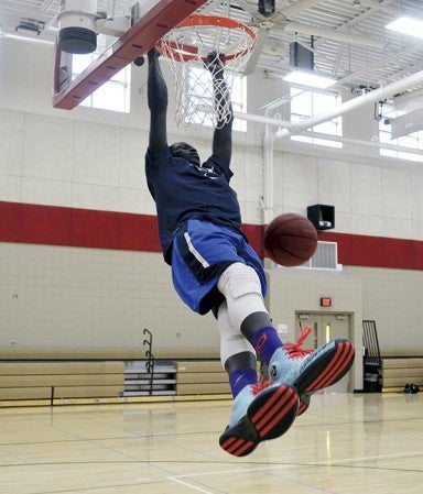 Gach Gach dunks in IJ Holton Gym recently. -- Rocky Hulne/sports@austindailyherald.com