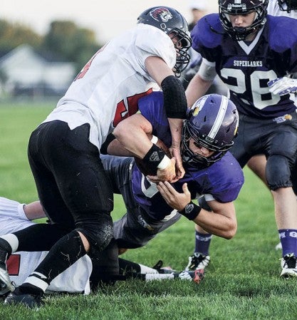 Grand Meadow's Landon Jacobson plunges in for a second-quarter touchdown against Spring Grove Friday night in Grand Meadow. Eric Johnson/photodesk@austindailyherald.com