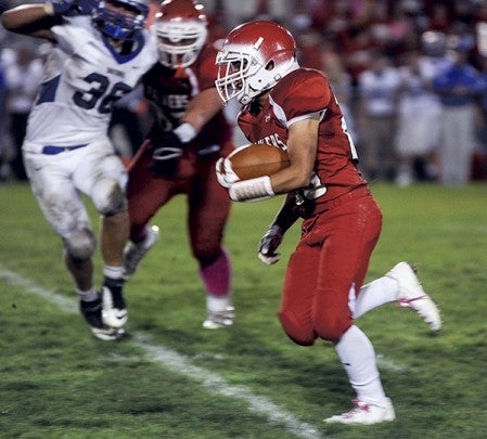 Austin's Brandon Edgar breaks free for a touchdown in the second quarter against Owatonna Friday night at Art Hass Stadium. Eric Johnson/photodesk@austindailyherald.com