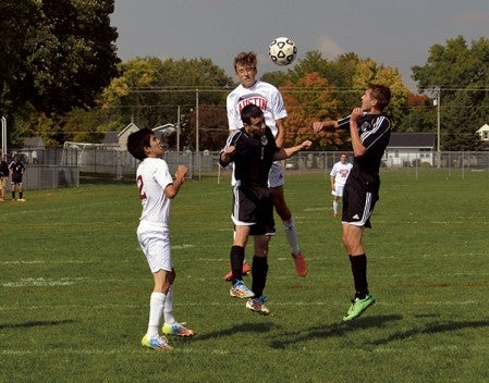 Jeremy Olmsted goes up for a header against Byron in Art Hass Stadium Saturday. -- Rocky Hulne/sports@austindailyherald.com