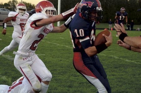 Austin's Connor Sheehan brings down Albert Lea quarterback Jake Kilby in the first half in Albert Lea in 2014. Herald File Photo