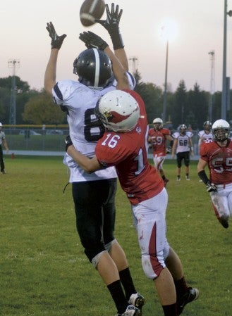 Blooming Prairie's Mitchell Jones goes up to catch a a pass against the defense of FBA's Anthony Van Thomme in Faribault Saturday. -- Rocky Hulne/sports@austindailyherald.com