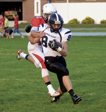 Cole Sunde tries to out-run Christian Von Ruden of FBA in Faribault Saturday. -- Rocky Hulne/sports@austindailyherald.com