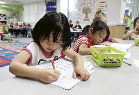 Paw Soe, left, and Mi Meh work on their language lessons at Woodson Kindergarten Center in Austin last Wednesday. Paw and Mi are Karen and Karenni and are part of the nearly 100 new Karen and Kareni students who have enrolled in Austin Public Schools. Alex Kolyer/For MPR News